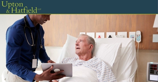 doctor examining x-ray with patient